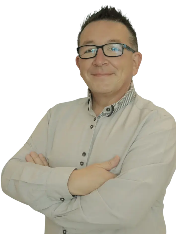 Carl Hinder standing in his office with his arms folded